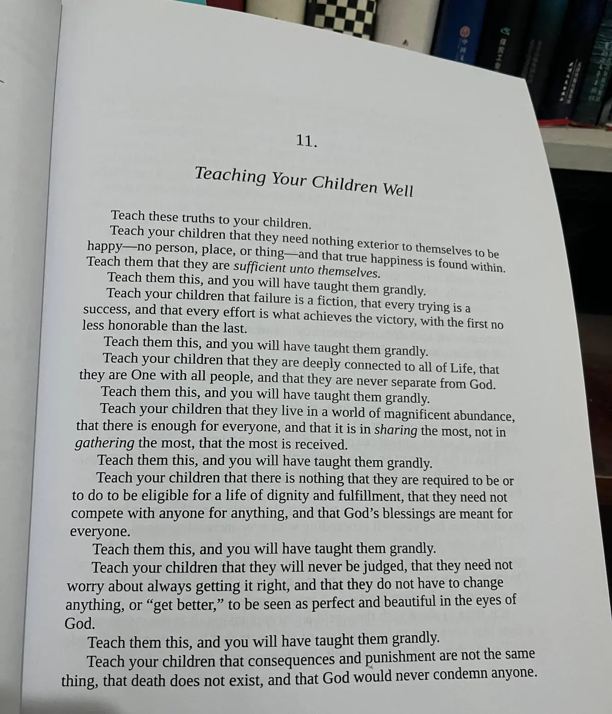 Open book page headed Teaching Your Children Well, photographed beside a bookshelf.